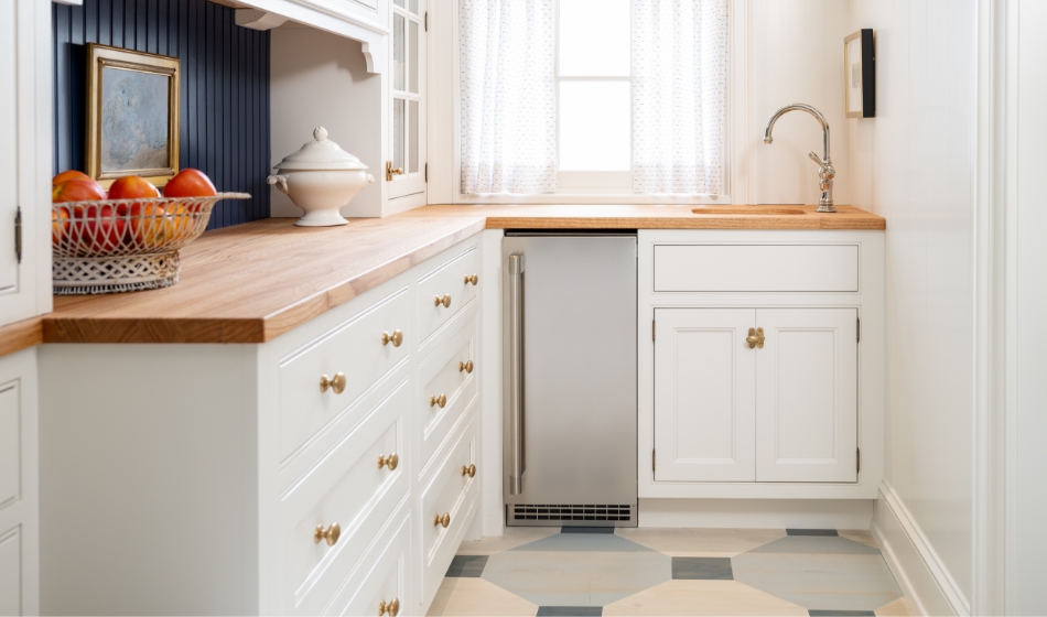 Stainless steel built-in gourmet clear ice maker integrated into cabinets in prep kitchen